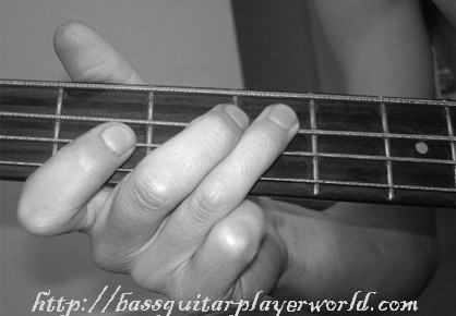 holding the bass by the fretboard